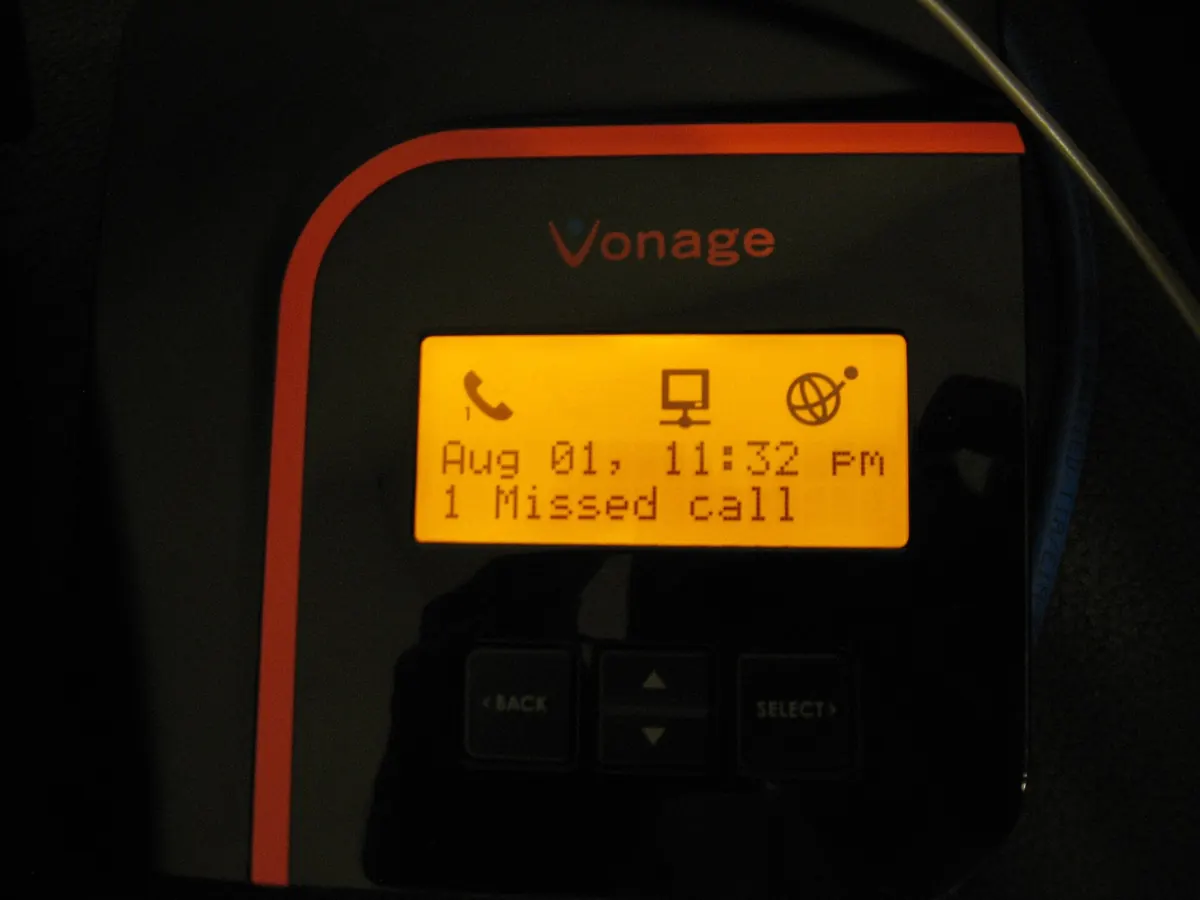 Orange phone adapter display showing one missed call