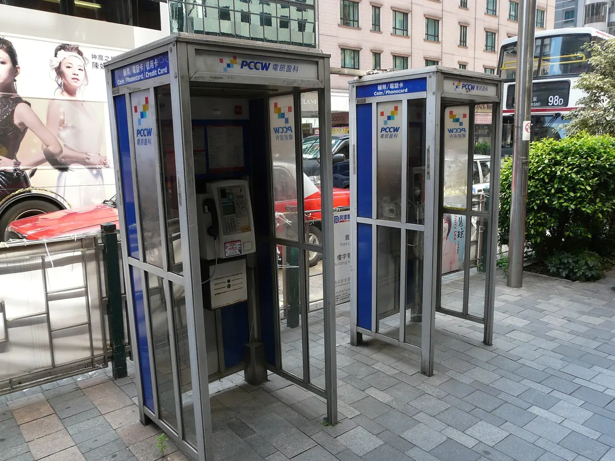 Two public phone booths on a Hong Kong pavement